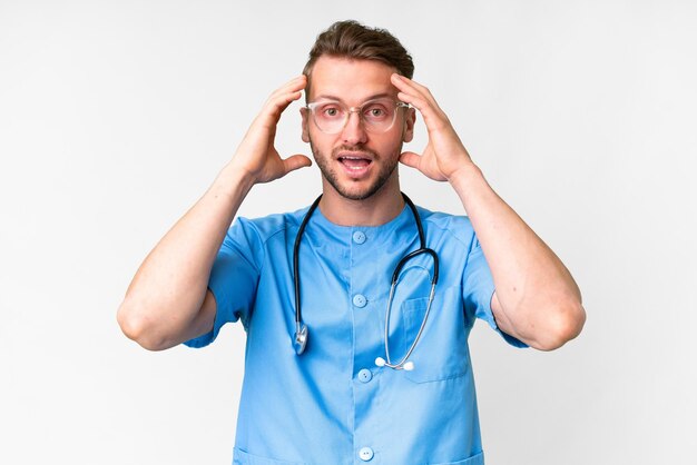 Young nurse man over isolated white background with surprise expression