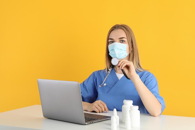 Young nurse sitting at the table, seasonal cold treatment