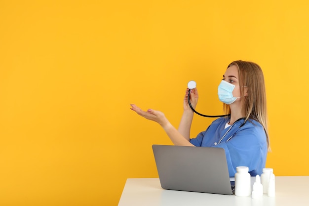 Young nurse sitting at the table, seasonal cold treatment