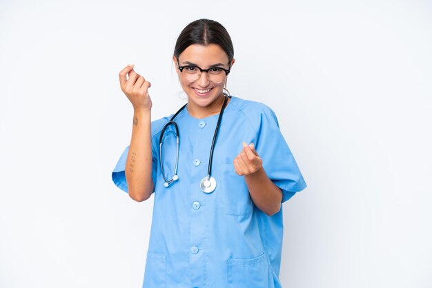 Photo young nurse woman isolated on white background making money gesture