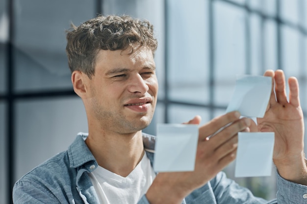 Young office man at workplace making notes