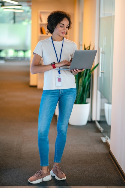 Young office worker with a laptop looking involved