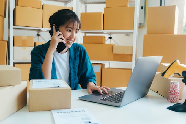 Young online business owner talking with customer on the phone