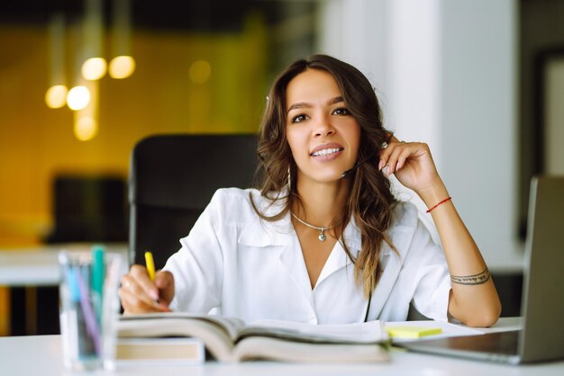 Young operator woman agent with headsets working in a call centre