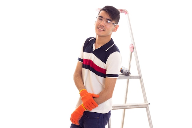 Young optimistic man with black hair in jeans white Tshirt and red checkered shirt with backpack