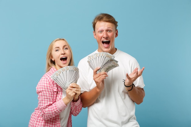 Young overjoyed couple two friends guy and woman in white pink t-shirts posing 