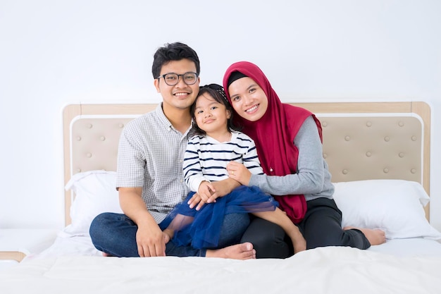 Young parents and child smiling at camera together