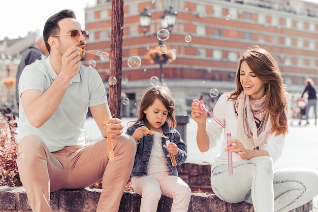 Young parents playing with their little daughter