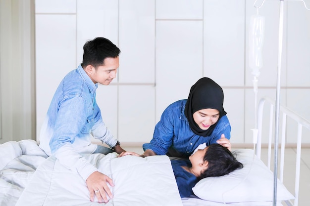 Young parents take care his sick son in hospital