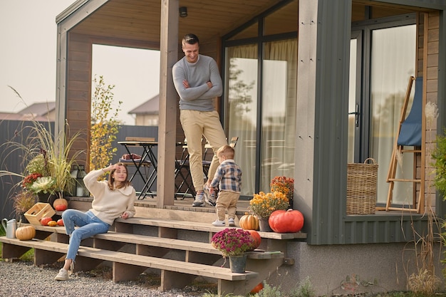 Young parents and their little kid on the veranda