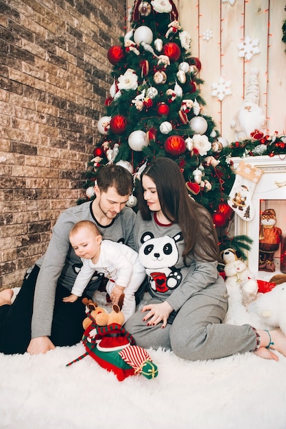 Young parents with young son near Christmas tree