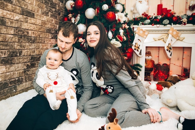 Young parents with young son near Christmas tree