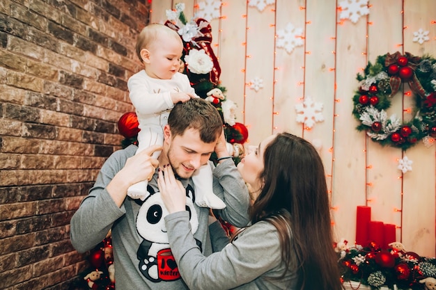 Young parents with young son near Christmas tree