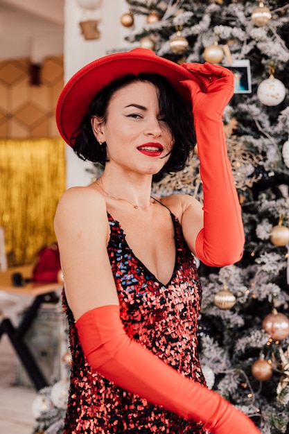 Young passionate girl posing near the Christmas tree