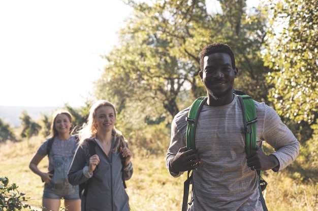 The young people are having fun while walking in the forest