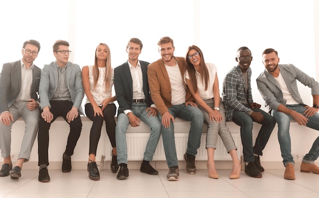 Young people are waiting for an interview sitting in the office lobby