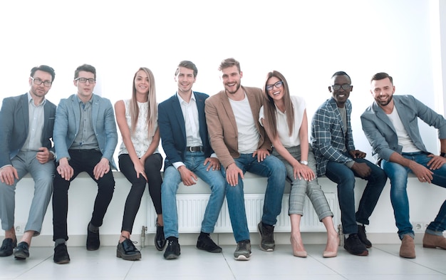 Young people are waiting for an interview sitting in the office lobby