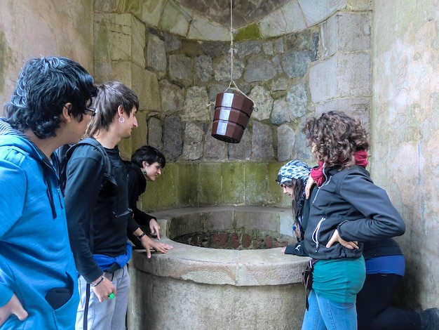 Young people around a wishing well