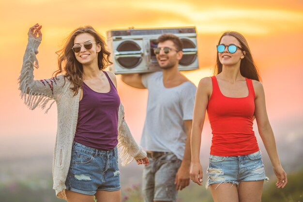 The young people dancing on the sunset background