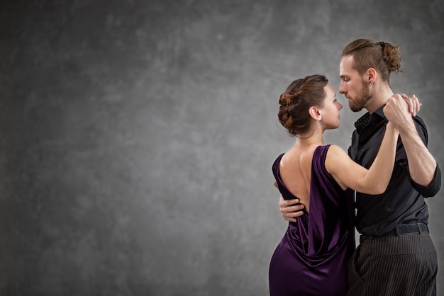 Young people dancing tango in a studio