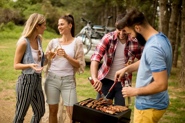 Young people enjoying barbecue party in the nature