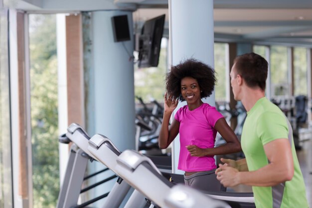 young people exercisinng a cardio on treadmill running machine in modern gym