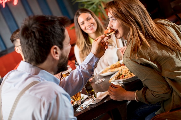 Young people having dinner in the restaurant