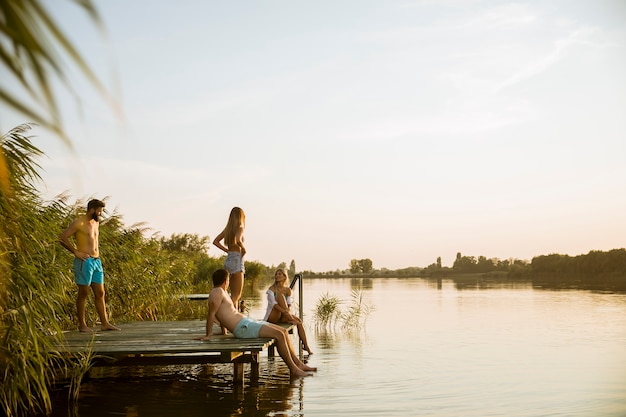 Young people having fun at the lake on a summer day