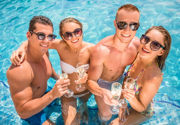 Young people having fun in swimming pool.