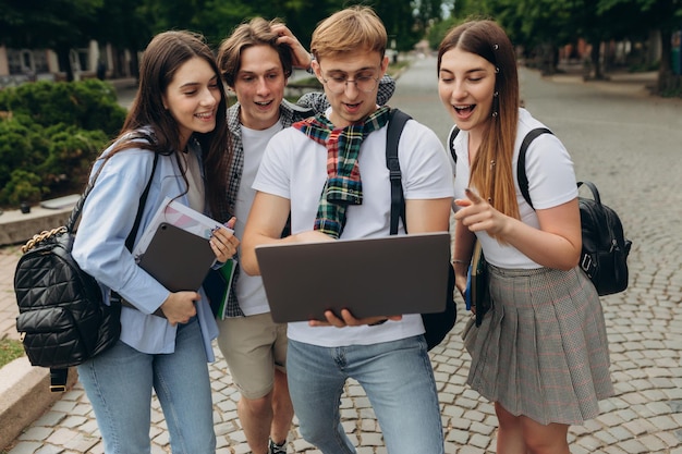 Young people looking at laptop together