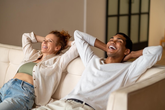 Young people lying on the sofa and looking relaxed