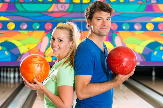 Young people playing bowling and having fun