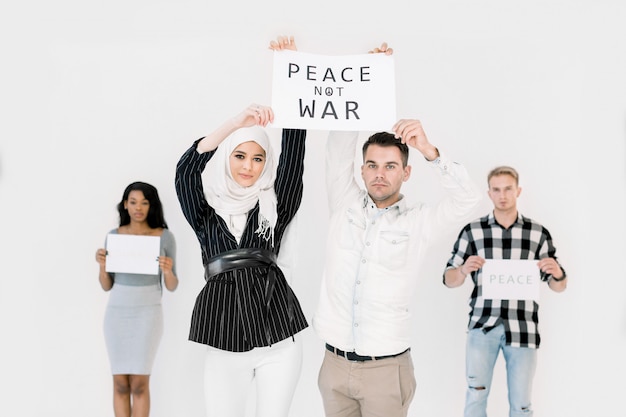 Young people showing slogans for world peace, against war and terrorism