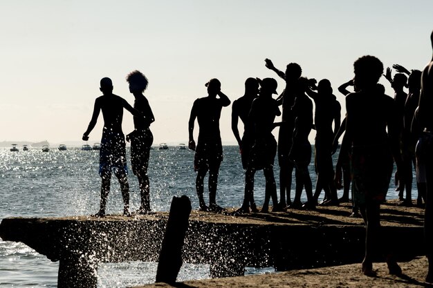 young people in silhouette are seen having fun on the Crush bridge in the late afternoon in the city of Salvador Bahia