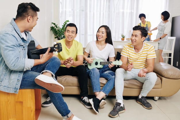 Young people singing at house party