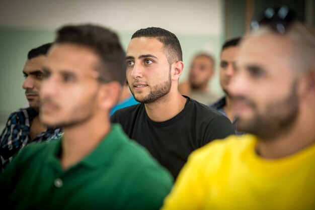 Young people sitting in class room