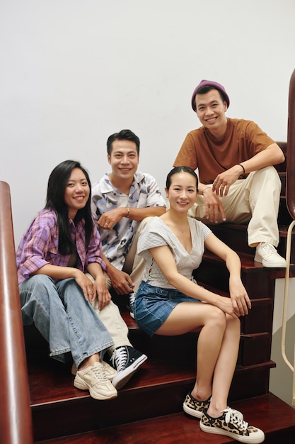 Young people sitting on wooden steps