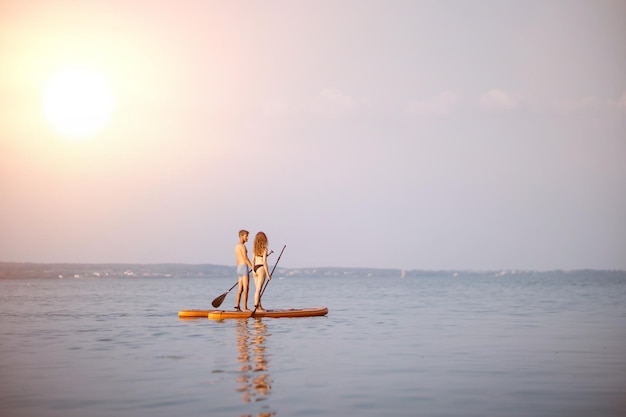 Young people traveling along the river on sap boards