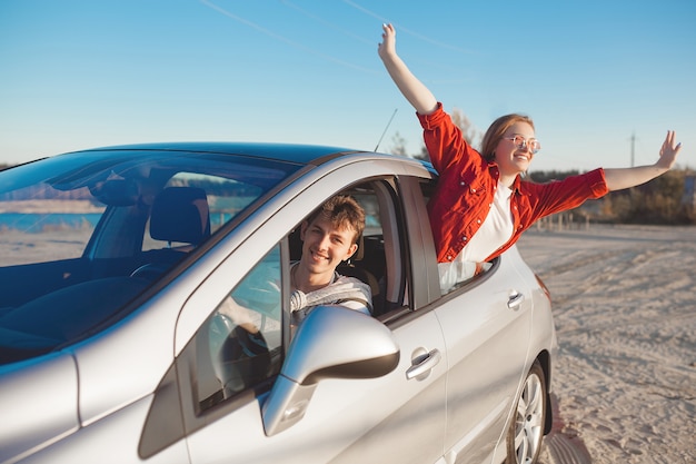 Young people traveling by car. Couple having an automobile trip.