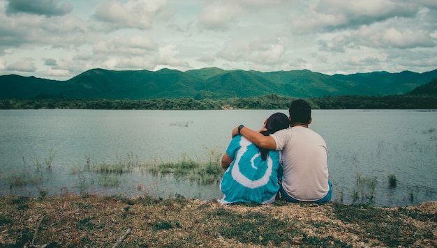 Young people watching the waterfront view mountains and rivers,  natural atmosphere.