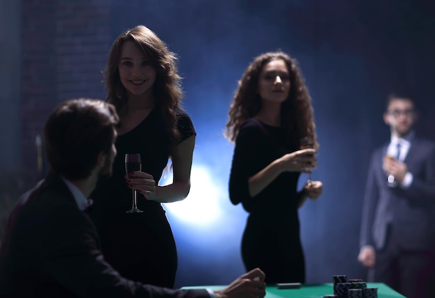 Young people with glasses of wine in a casino