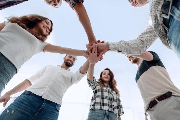 Young people with hands clasped together