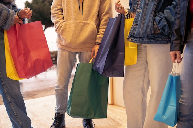 Young people with shopping bag at the shopping mall center - midsection