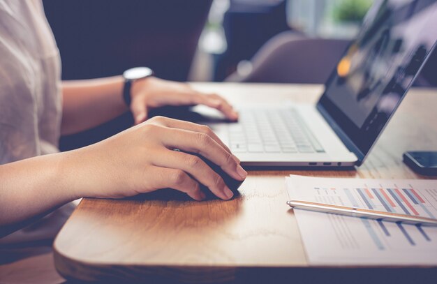 Young people working with modern laptop in workplace