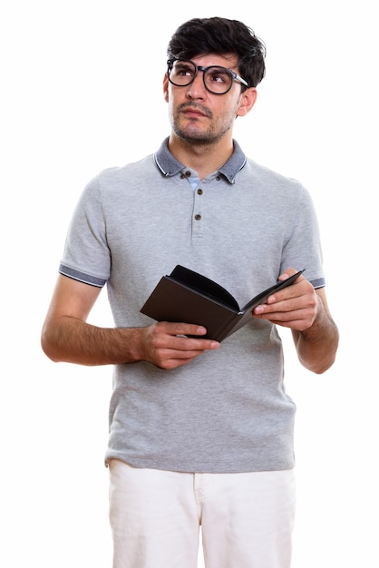 young Persian man holding book while thinking
