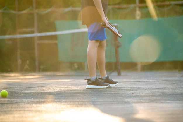 Young person enjoy summer family weekend activities on the tennis courts