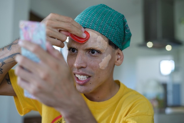 Young person of nonbinary gender performing drag queen makeup