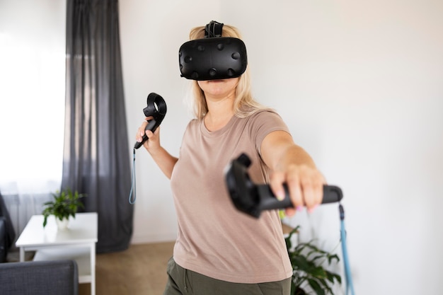 Photo young person playing videogames with vr glasses