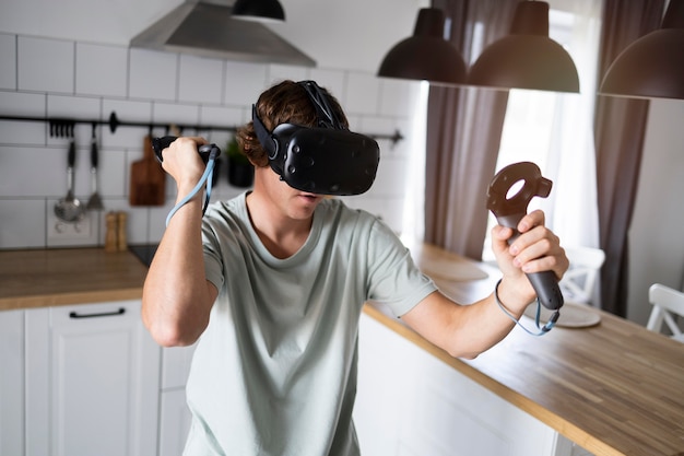 Young person playing videogames with vr glasses