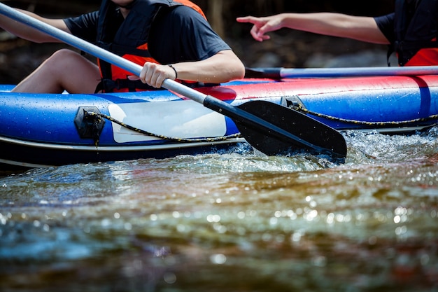 Young person rafting in a river.